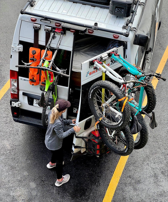 3 bicycles on a campervan rear door 