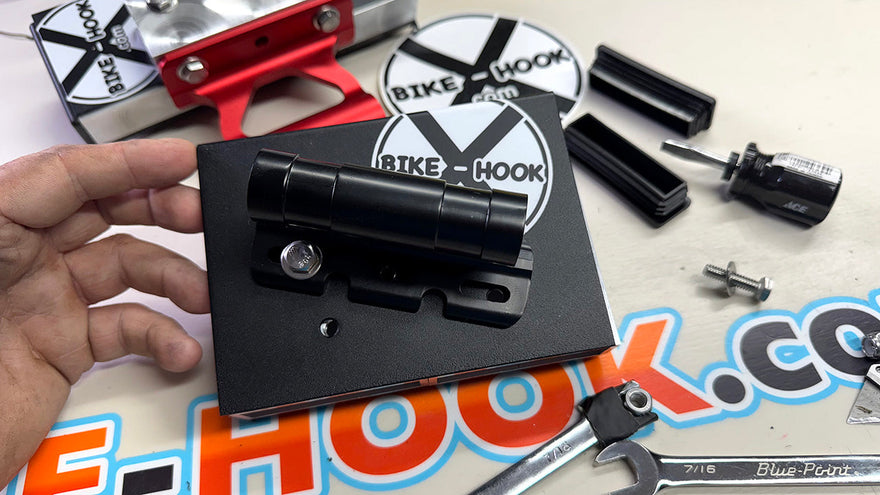 Bike-Hook fork mount installed on rear van door carrying a bicycle securely for campervan travel.