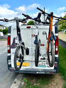 Renault Trafic with a vertical bike rack carrying three bicycles on the rear doors