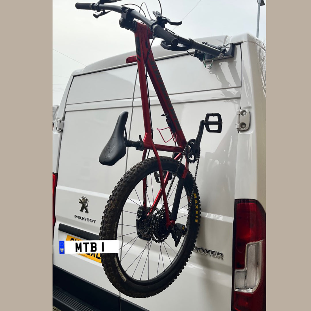 Peugeot Boxer campervan equipped with Bike-Hook fork-mount bike rack for easy bike transport.

