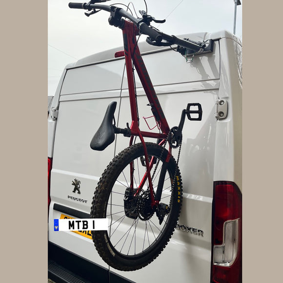 Peugeot Boxer campervan equipped with Bike-Hook fork-mount bike rack for easy bike transport.

