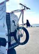 Fork mount bike rack installed on a Ford Transit Connect rear door using the Bike-Hook system. Holds bikes vertically without drilling or a hitch, perfect for campervan travel.

