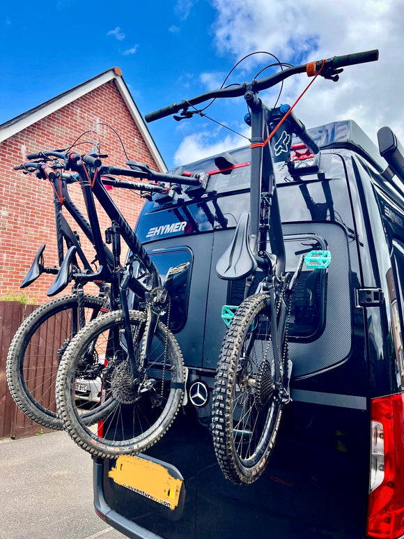 Lightweight and low-profile Bike-Hook mount for Mercedes Sprinter Rear door bike rack system holds up to 4 bikes vertically without blocking entry. Works with Sprinter, Transit, ProMaster, VW Transporter, and more. Compatible with EU van models.
