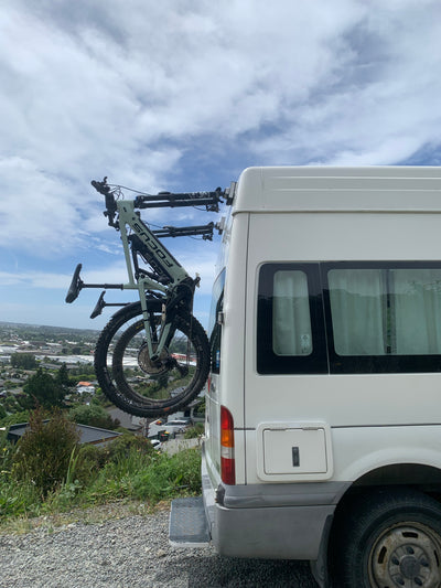 Adventure van with 3 bikes on rear doors using Bike-Hooks. Modular design lets vanlifers avoid bulky swing-away racks for e-bikes or mountain bikes.


